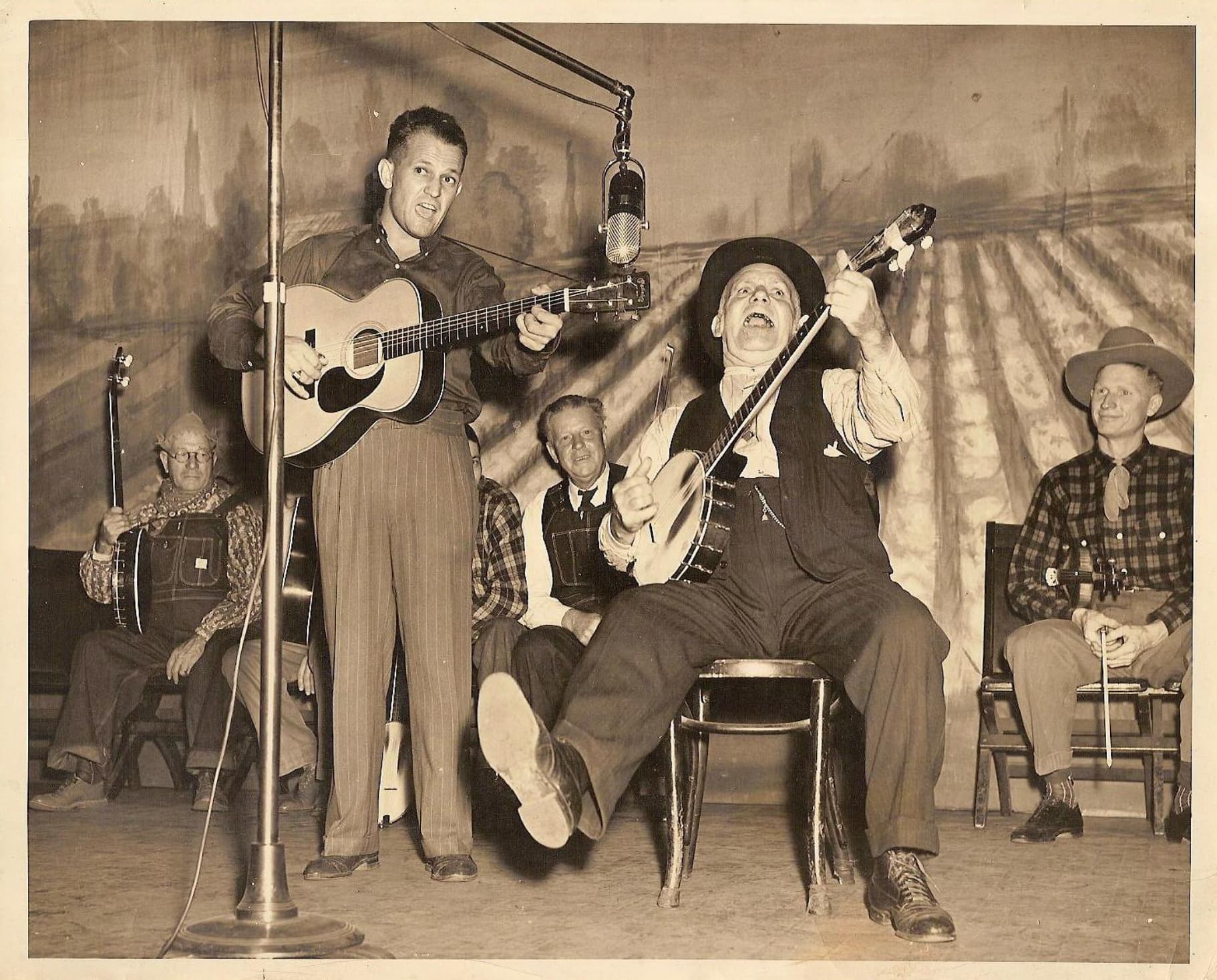 “America's first country music star, Uncle Dave Macon, with son Dorris. Grand Ole Opry stage. Nashville, TN. 1930’s.”